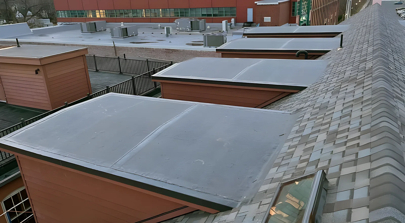 New low-slope membrane roof sections on a brick building
